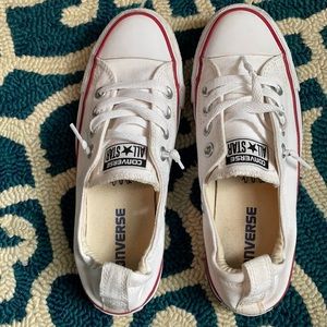 White converse slip on shoes with red trim